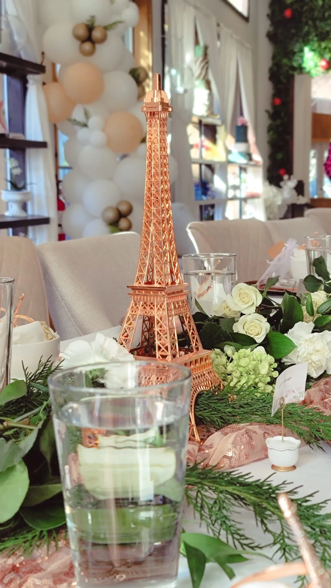 Romantic floral banquet table with pink linens, gold vessels, and silk floral arrangements